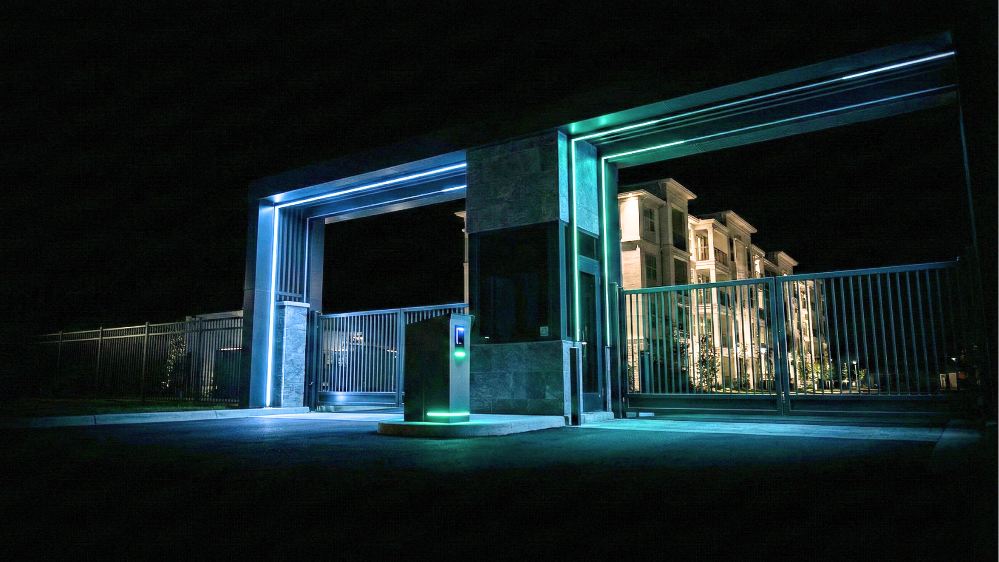 Multifamily community entry gate at night