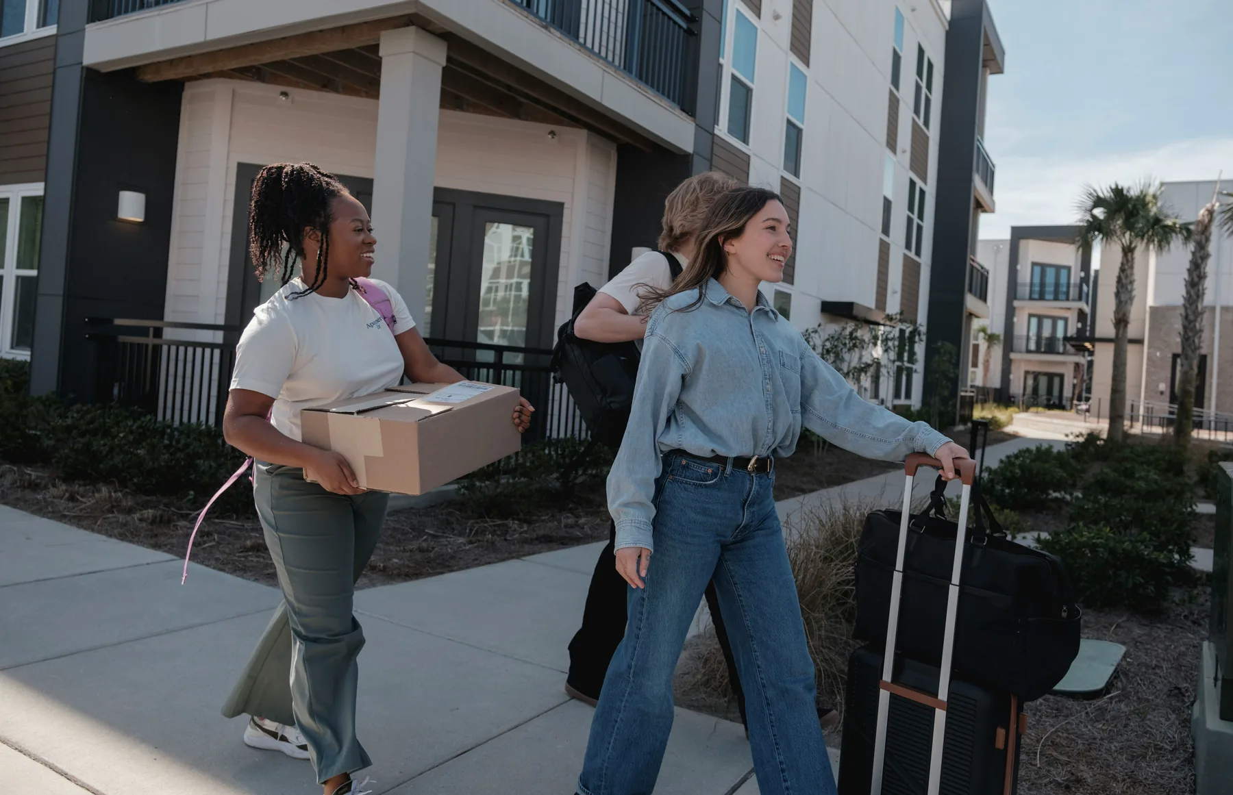 Residents arriving at a modern multifamily community